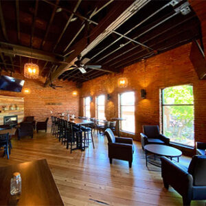 Elegant seating and tables with scenic views at Portside Stillwater nightclub, offering a captivating atmosphere.