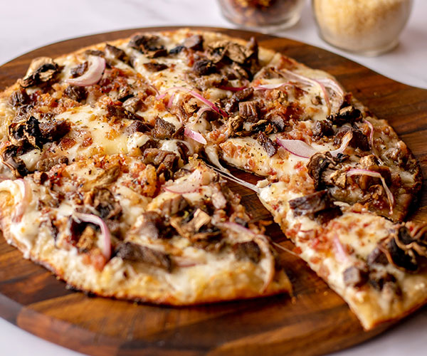 Mouthwatering pizza from Portside restaurant and nightclub, showcasing delectable offerings on their food menu.